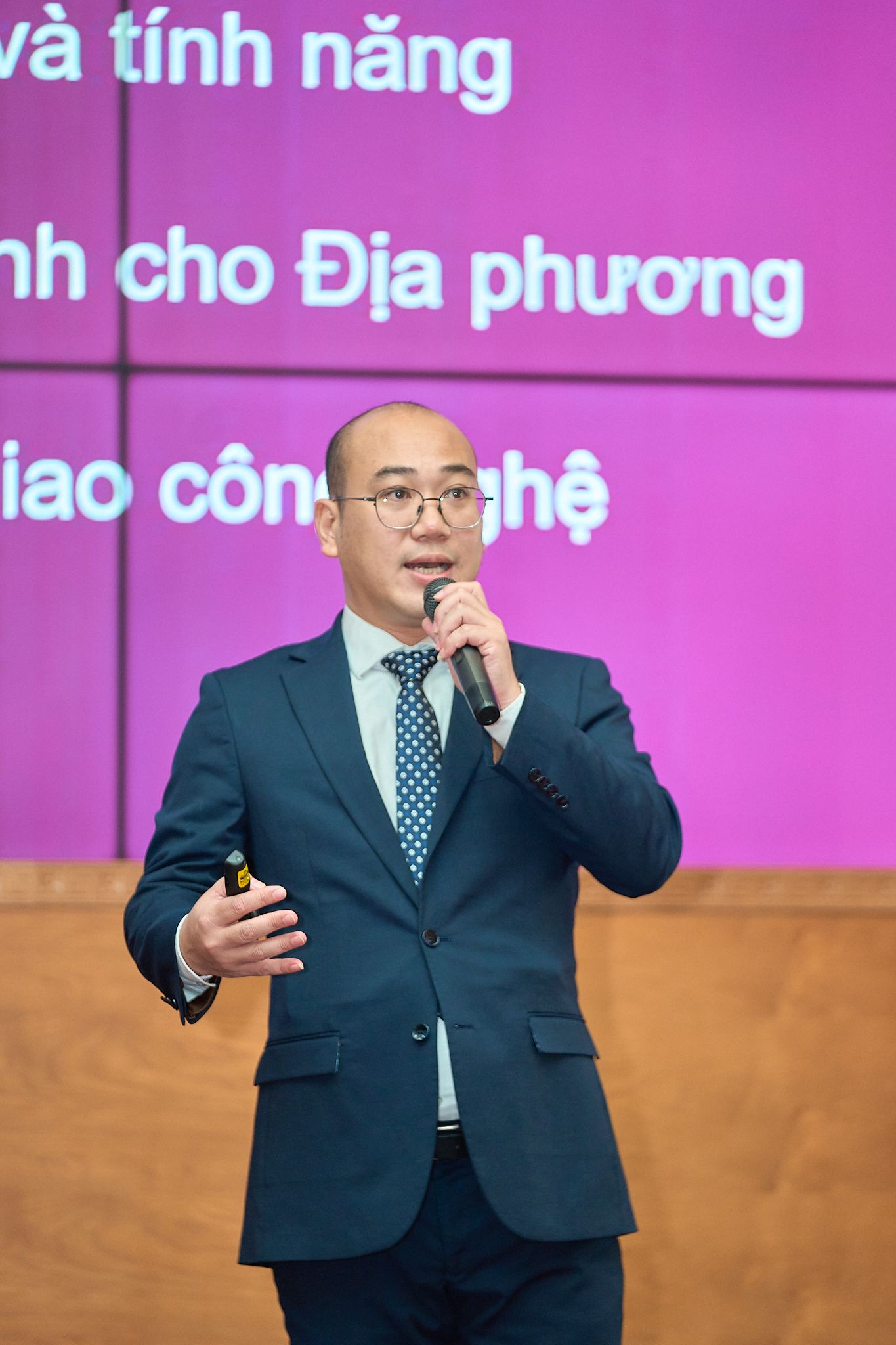 Delicate pink magnolia flowers bloom against a pale sky.